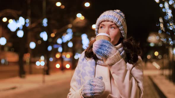 Happy Woman with Coffee and Shopping Bag in Winter