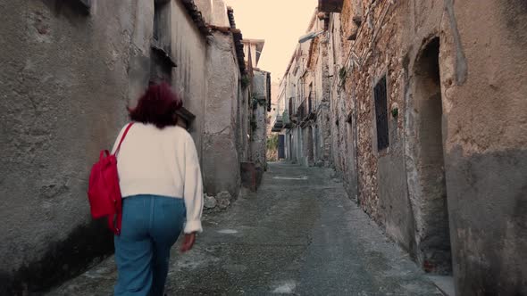 Girl is visiting an abandoned city in Italy