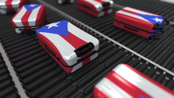 Suitcases with Flag of Puerto Rico on Roller Conveyer