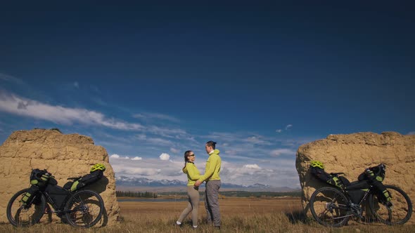 The Man and Woman Travel on Mixed Terrain Cycle Touring with Bikepacking