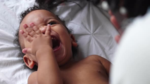 Happy Mixedrace Baby Boy Laughing and Clapping