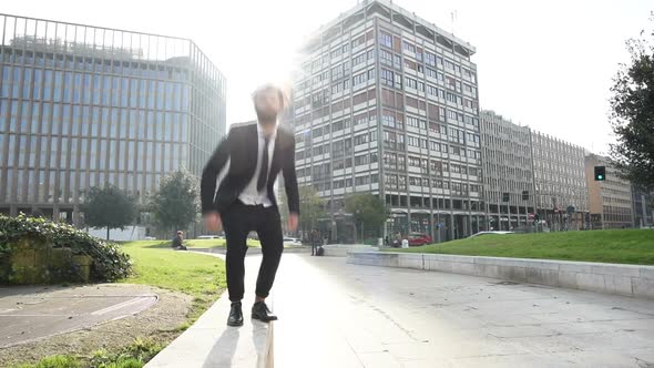 Slow motion young smart casual bearded man jumping outdoor