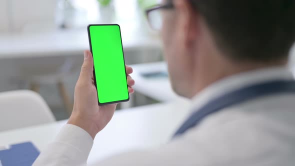 Doctor Holding Smartphone with Green Chroma Key Screen