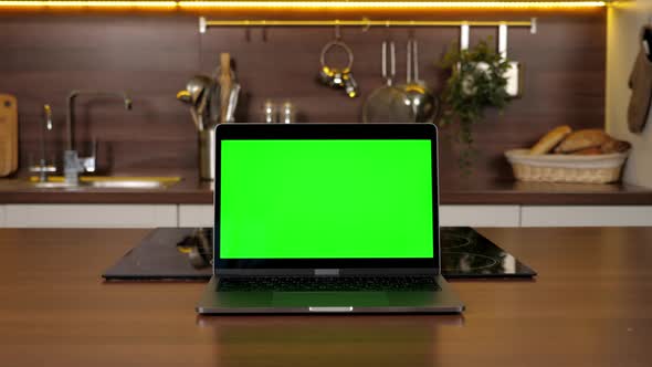 Green Screen Laptop Standing on Kitchen Table Computer with Chroma Key Display