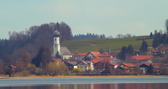 Closeup shot of Gmund and its church from the other side of the Tegernsee.