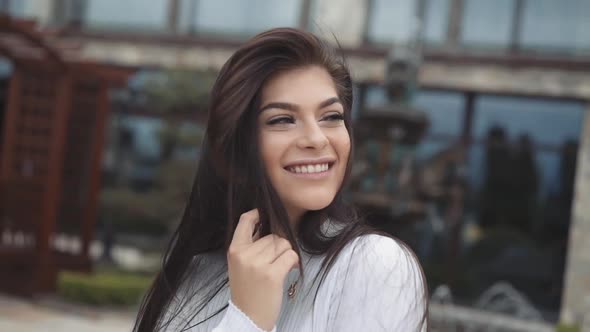 Beautiful Portrait of Brunette with Blowing Long Hair