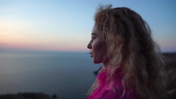 Close Up Shot of Beautiful Young Caucasian Woman with Curly Blond Hair and Freckles Looking at