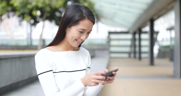 Young Woman Look at Mobile Phone at Outdoor