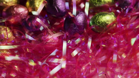 Rotating shot of colorful Easter candies on a bed of easter grass