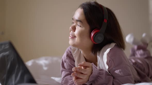 Portrait of Joyful Relaxed Little Person Singing Listening to Music in Headphones