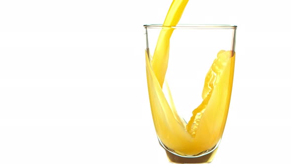 Super Slow Motion Shot of Pouring Fresh Orange Juice Into Glass at 1000 Fps