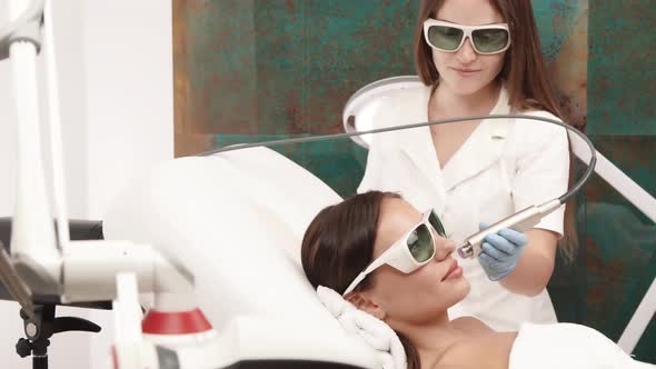 Beautican Working on Female Face with Erbium Laser