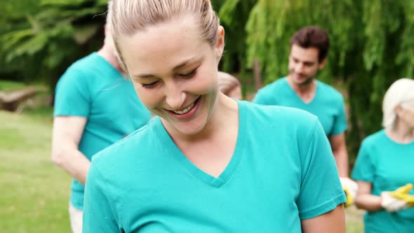 Female volunteer holding recycle bin in the park