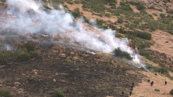 Firefighters putting out wildfire burning on mountain in Utah