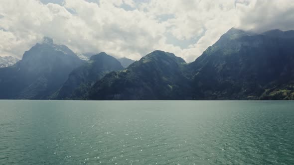 Scenic Drone Footage of a Lake View at the Foot of the Alps in Switzerland