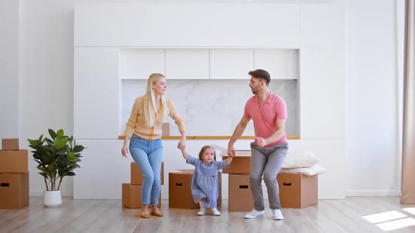 Happy family parents and preschooler daughter new apartment