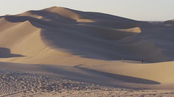 Two people visiting the sand dunes