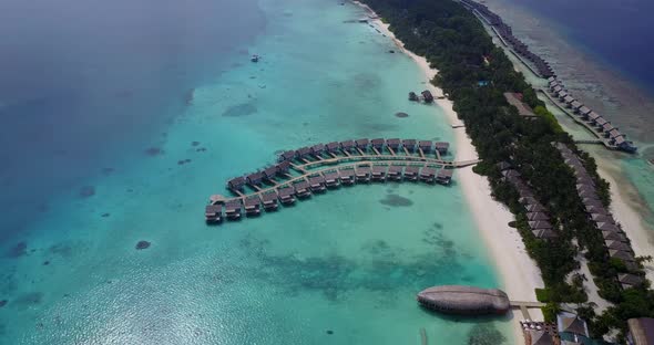 Natural above clean view of a paradise sunny white sand beach and blue ocean background in colorful 