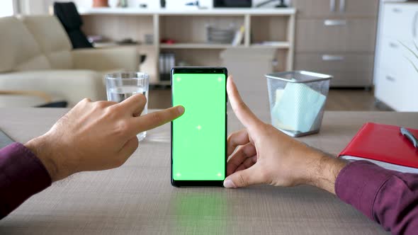 Man Touching Smartphone Screen with Chroma Mock Up on It