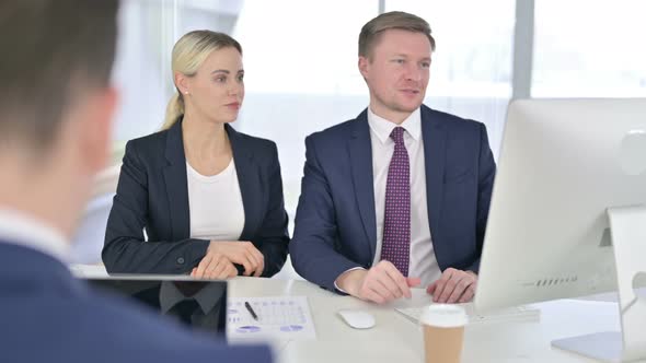 Cheerful Business Team Doing Video Chat on Desktop