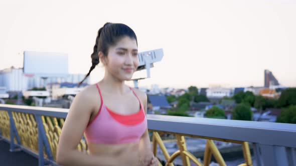 Young Woman Running at Bridge