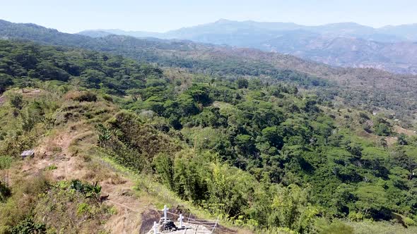 Aerial rising over 3 white crosses crucifix in the mountains of Timor Leste, Southeast Asia with hig