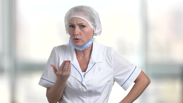 Angry Woman Doctor on Blurred Background.