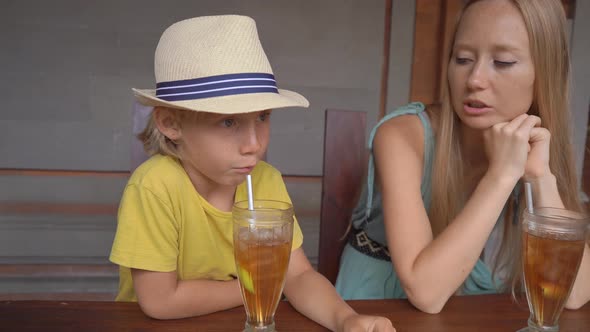 Young Woman and Her Little Son Eat Traditional Balenese Food Set Nasi Campur in a Traditional Cafe