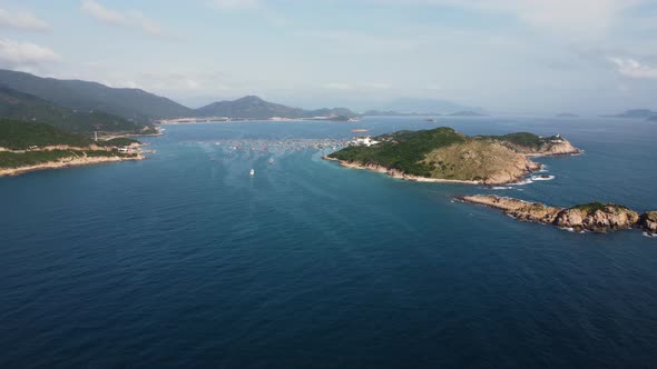 Aerial drone shot of beautiful Binh hung bay with islands and coastline during sunny day in Vietnam