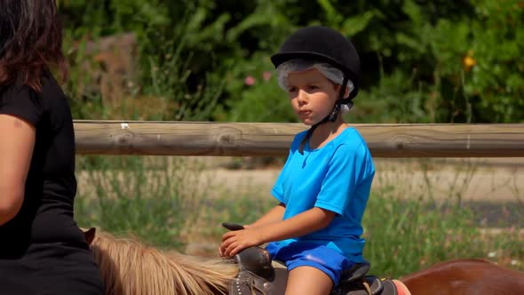 Little Boy Rides a Pony and Play Up