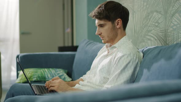 Focused Businessman Working Laptop in Hotel Room. Man Typing Computer Hotel Room