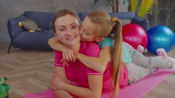 Fitness Mom and Daughter Resting After Workout