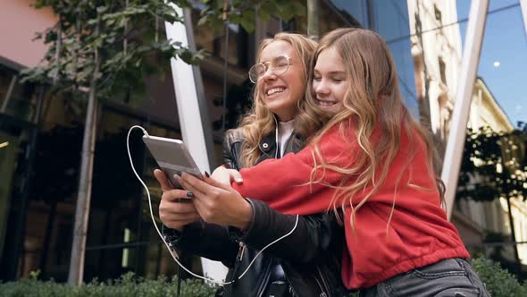 Two Women Friends Using Digital Tablet in Outdoors