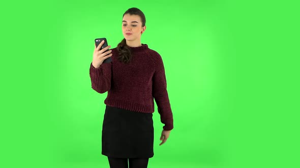 Girl Talking for Video Chat Using Mobile Phone on Green Screen