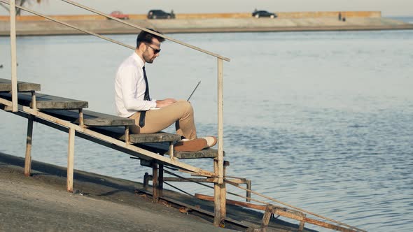 Businessman And Laptop On Steps.Freelancer Internet Online Meeting Webinar.Man Freelance And Compute