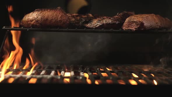 Cooking Meat on grill. meat is roasted on hot grill  with sparks.