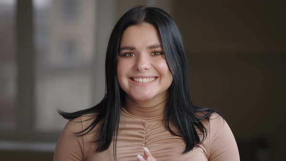 Portrait of Caucasian Mexican Spaniard Millennial Girl Rejoices Good News Holding Her Head and Face