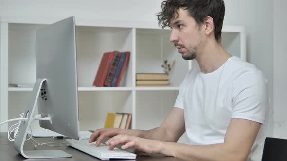 Young Creative Man Leaving Office After Working On Desktop