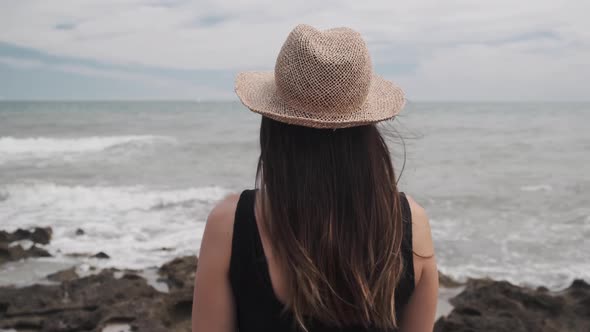 Woman In A Hat Looking At The Sea