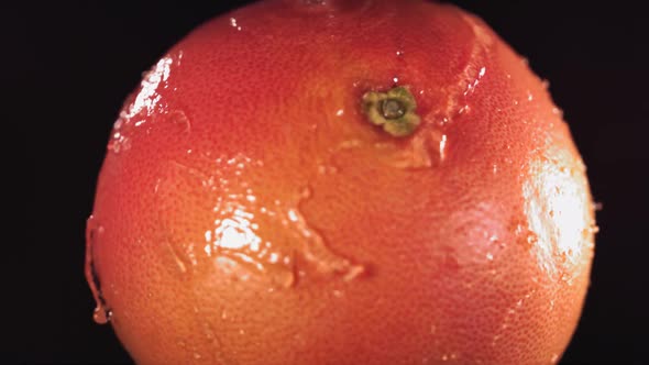 Super Slow Motion Water Drips on Rotating Grapefruit