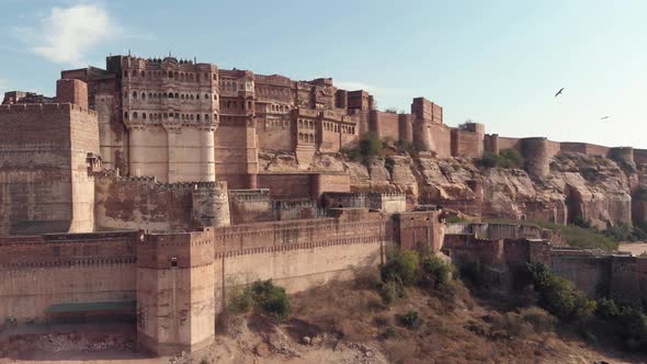 Mehrangarh Fort on a sunny day with birds flying around in Jodhpur, Rajasthan, India