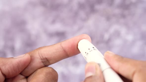 Young Man's Hand Measure Glucose Level at Home