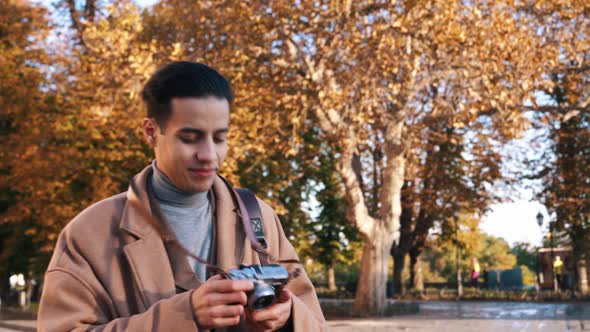 Positive Arabian man taking street photos