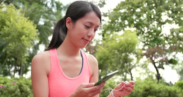 Sport woman listen to music on cellphone at outdoor