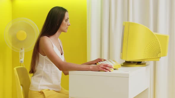 Woman Is Working at Yellow PC