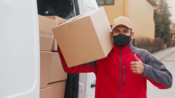 Courier Delivering Parcels During Covid19 Man Wearing Mask While Carrying Boxes