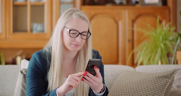 Businesswoman Using Mobile Phone On Sofa