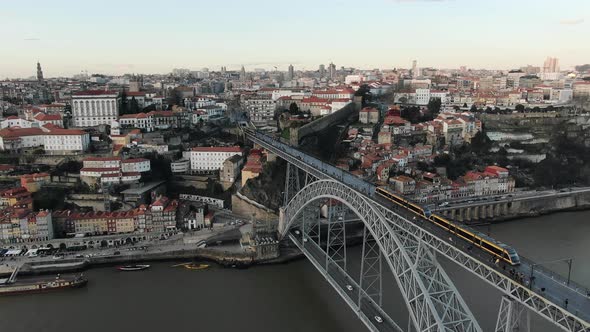 Shuttle Tram Rides on Ponte Luis Metal Bridge Over River