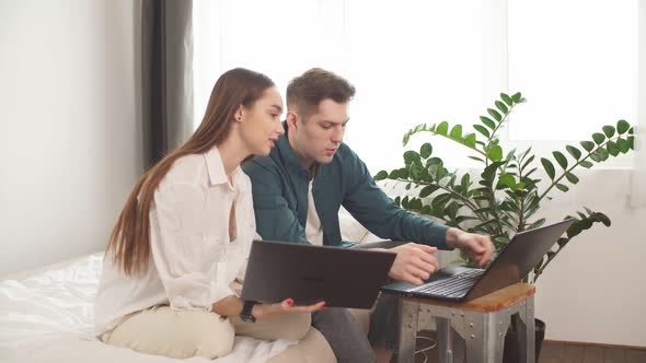 Young Caucasian Married Couple Using Laptop.