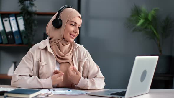 Friendly Saudi Business Female in Hijab Talking Online Video Call Laptop Colleagues Remotely Meet Up